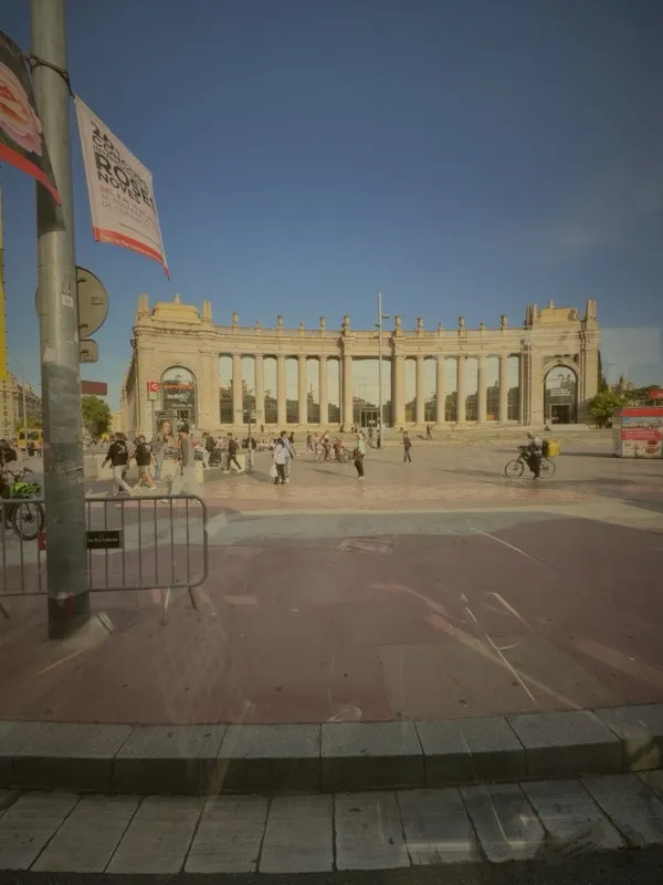 Grand classical building with pink plaza in Barcelona